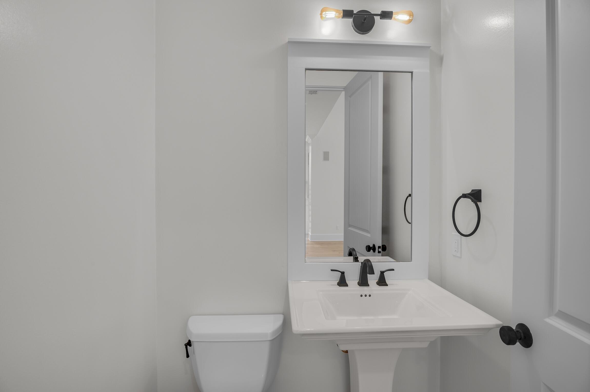 488 Regatta Bay Boulevard Destin, FL 32541 - Photo 12 of 46 a bathroom with a sink a toilet and mirror