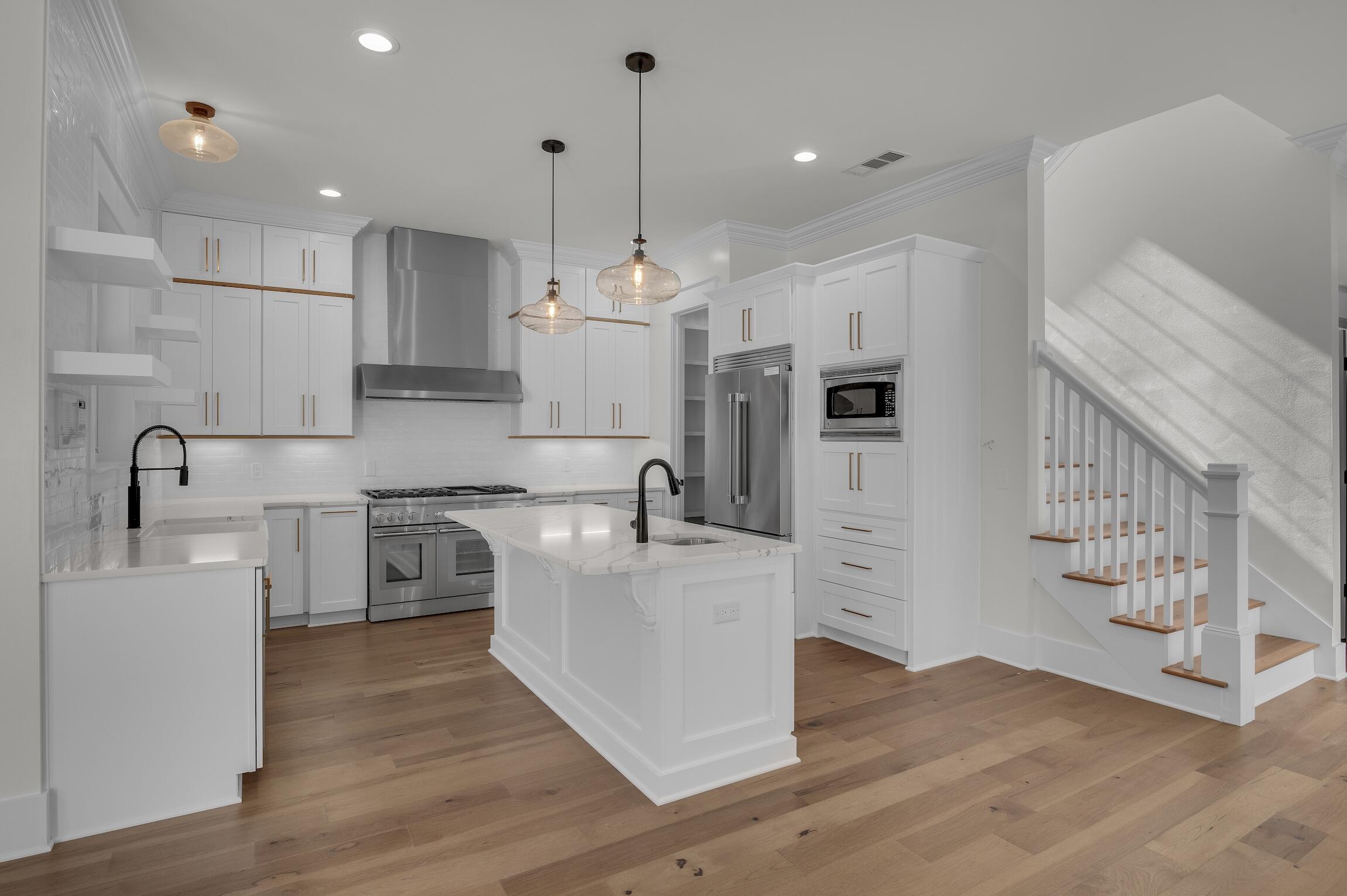 488 Regatta Bay Boulevard Destin, FL 32541 - Photo 13 of 46 a kitchen with stainless steel appliances granite countertop a refrigerator a stove a sink and a wooden floors