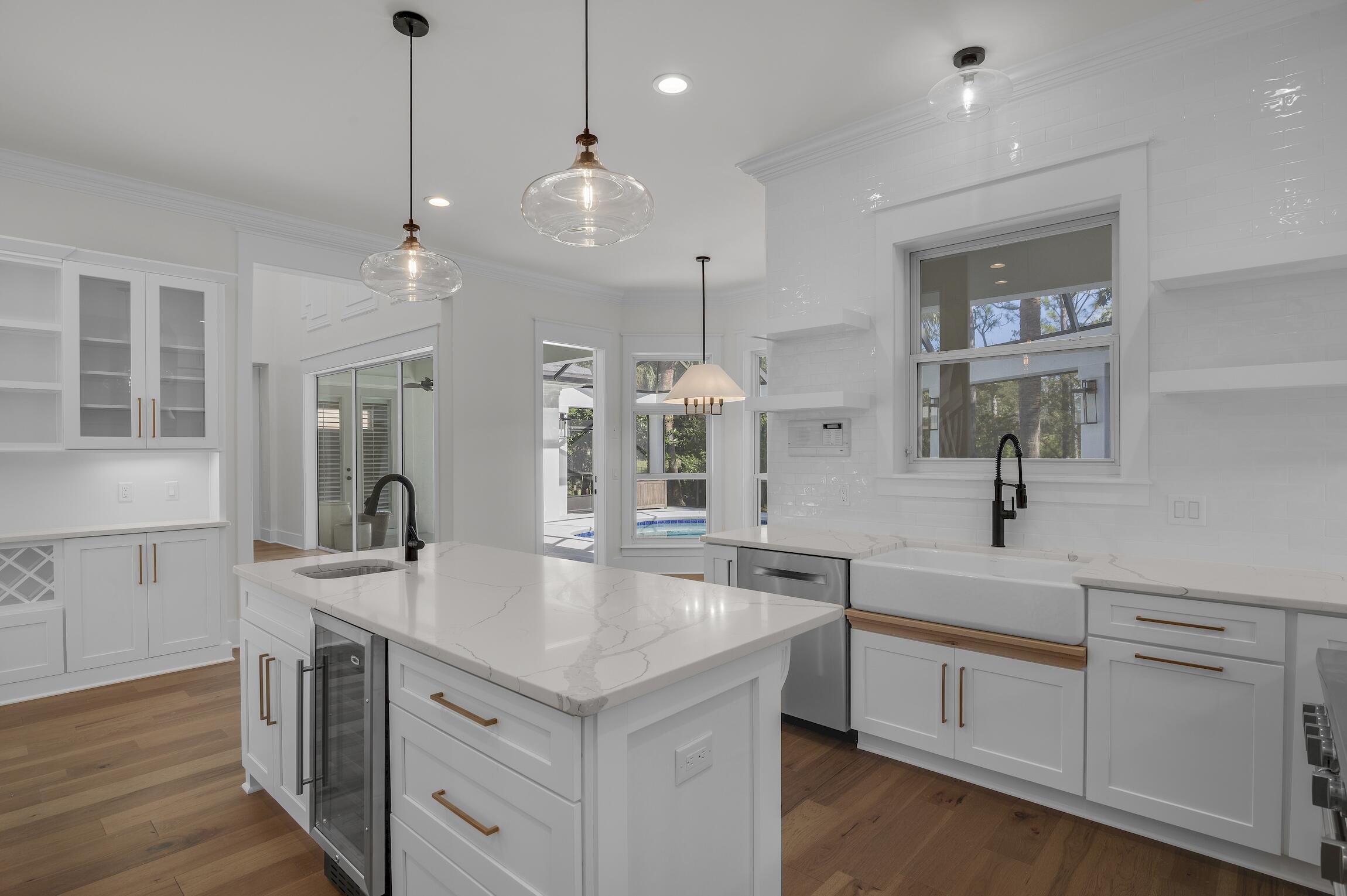 488 Regatta Bay Boulevard Destin, FL 32541 - Photo 15 of 46 a large kitchen with cabinets a sink dishwasher and a large refrigerator with wooden floor