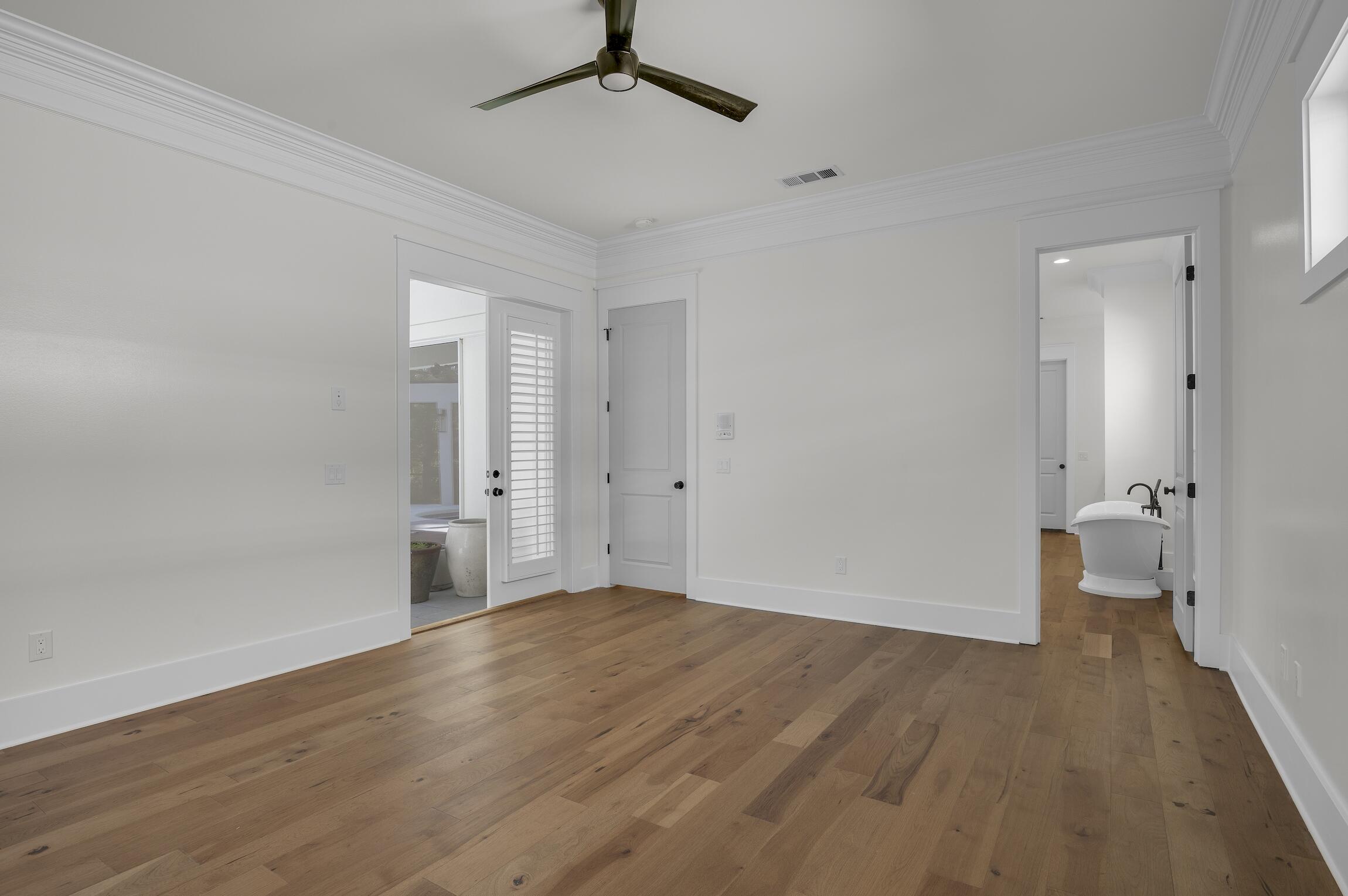 488 Regatta Bay Boulevard Destin, FL 32541 - Photo 21 of 46 a view of a room with wooden floor and a ceiling fan