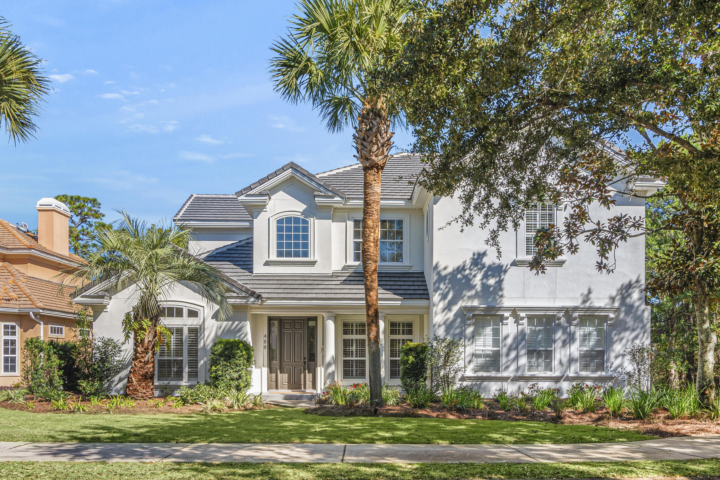 488 Regatta Bay Boulevard Destin, FL 32541 - Photo 3 of 46 a front view of a house with a garden
