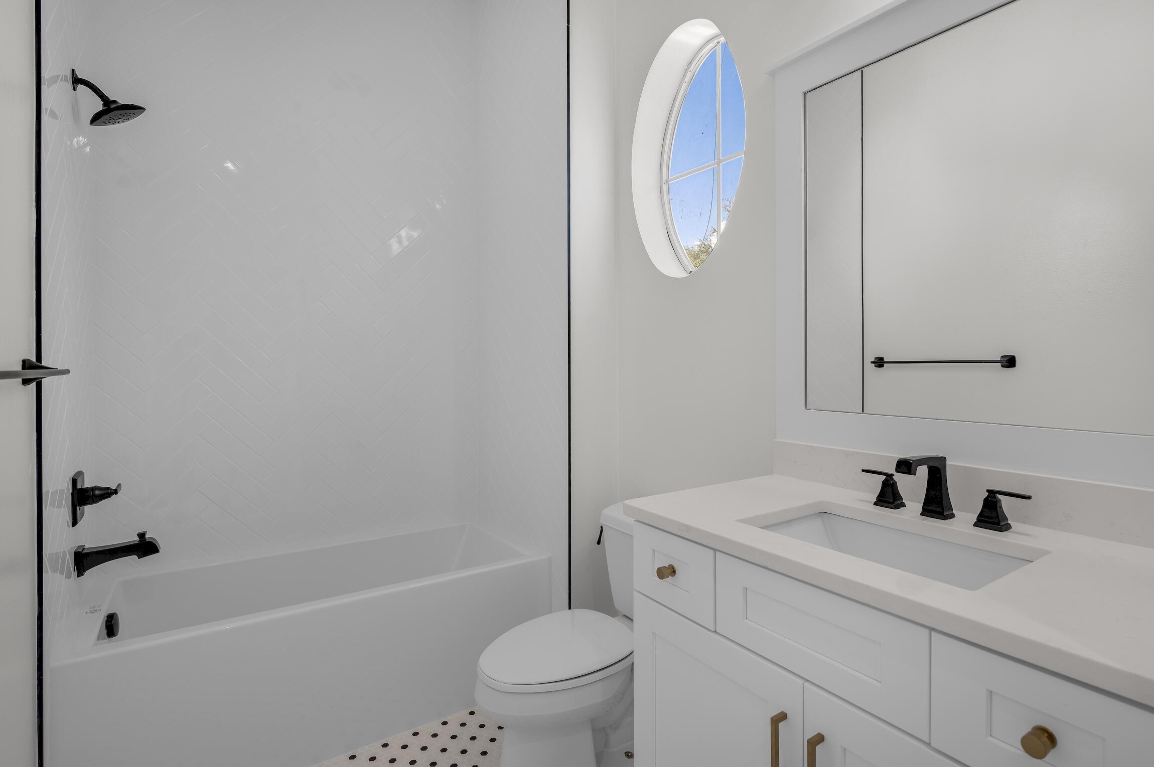 488 Regatta Bay Boulevard Destin, FL 32541 - Photo 31 of 46 a bathroom with a sink a toilet a mirror a vanity and shower