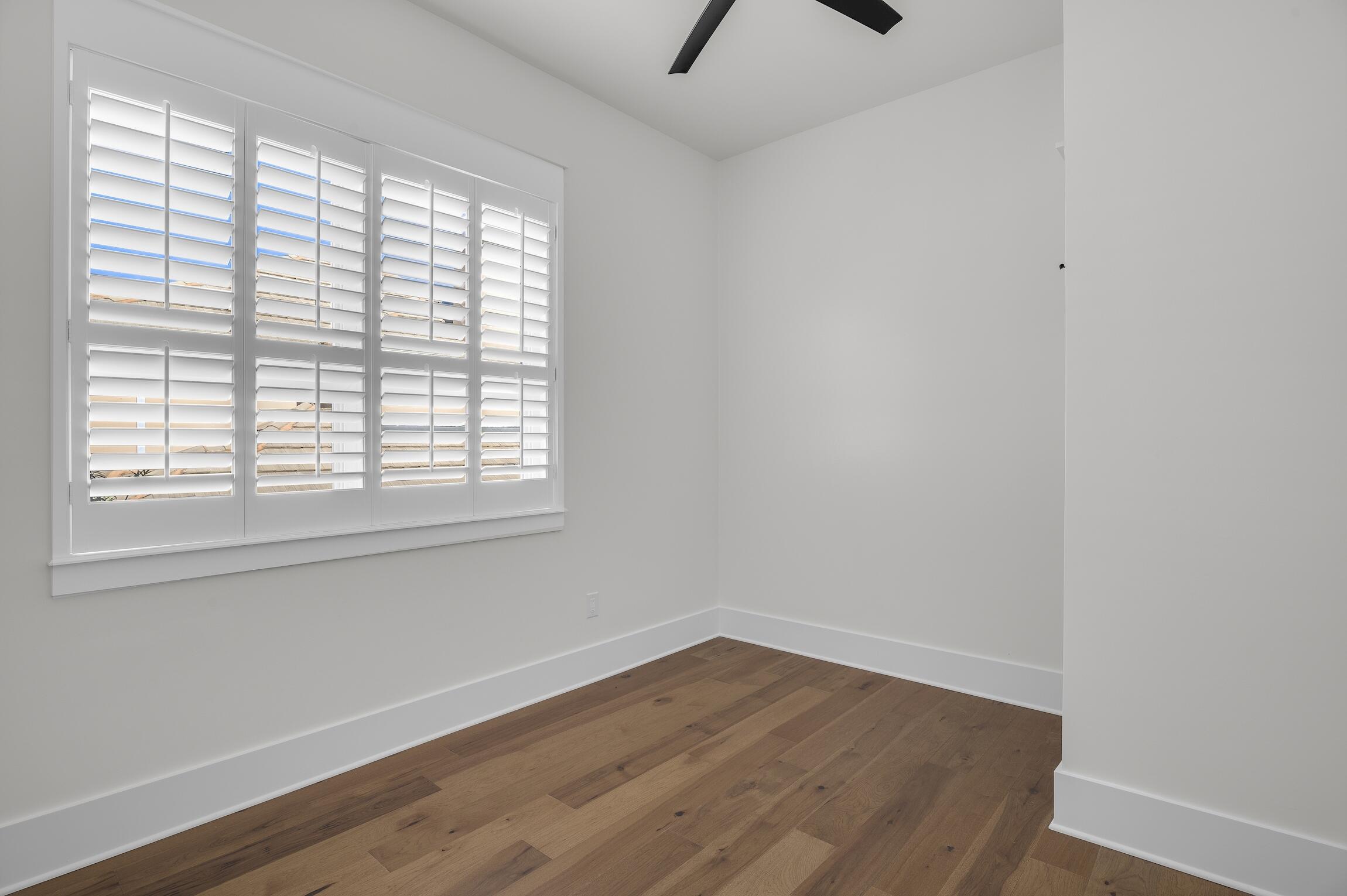 488 Regatta Bay Boulevard Destin, FL 32541 - Photo 37 of 46 an empty room with wooden floor and windows