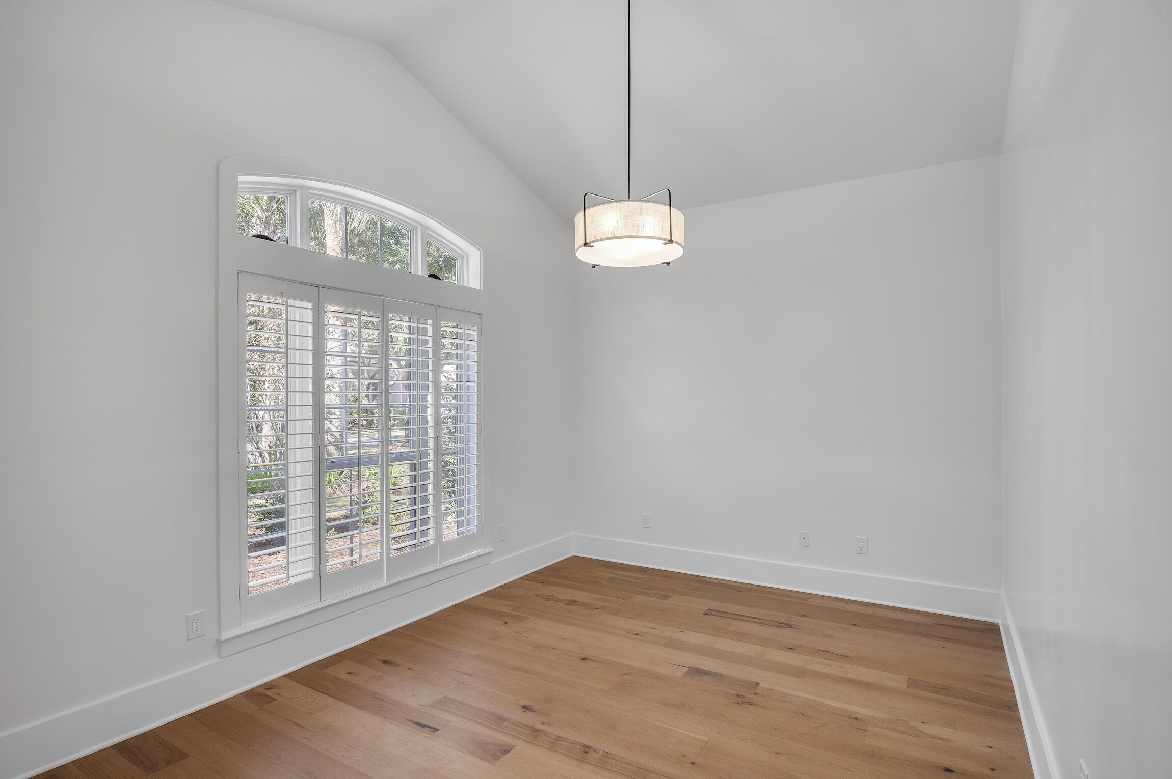 488 Regatta Bay Boulevard Destin, FL 32541 - Photo 7 of 46 a view of an empty room with wooden floor and a window