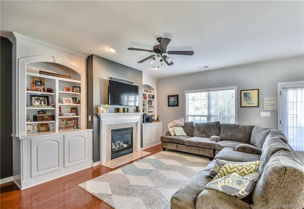 225 Mott Road Mooresville, NC 28115 - Photo 11 of 24 a living room with furniture a fireplace and a flat screen tv