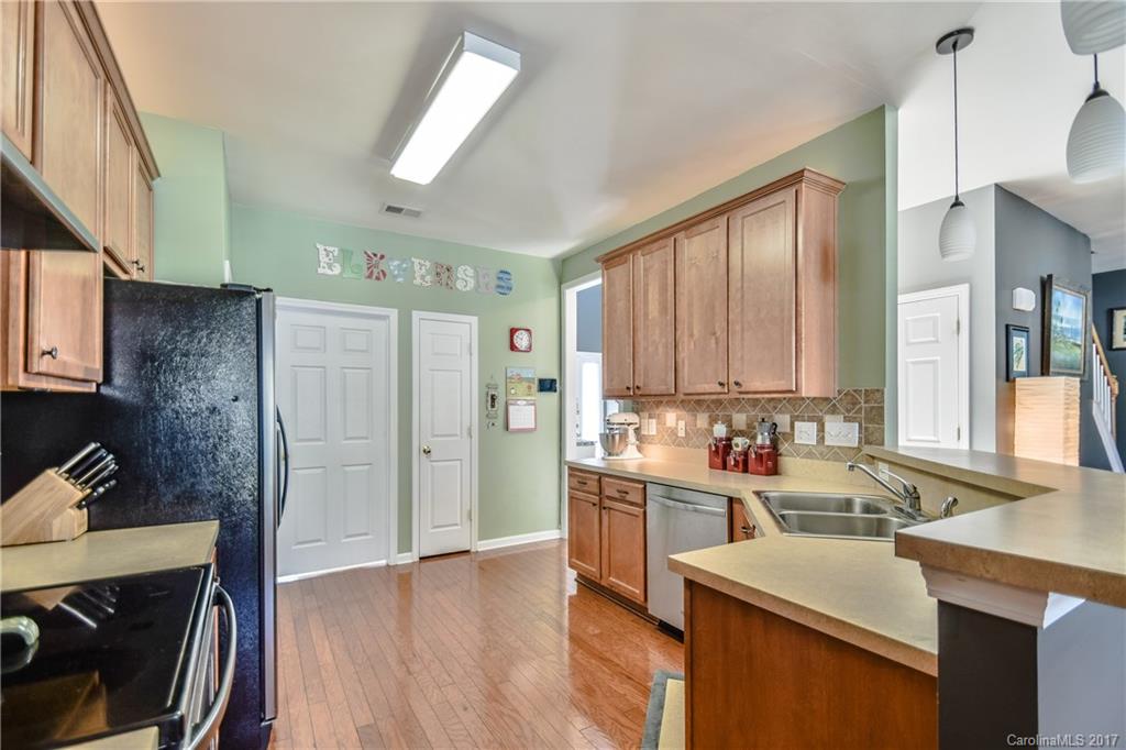 225 Mott Road Mooresville, NC 28115 - Photo 13 of 24 a kitchen with a sink stove and cabinets