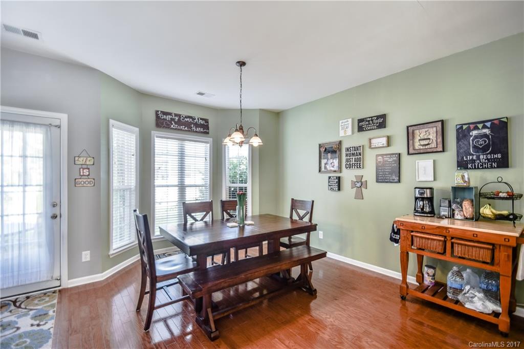 225 Mott Road Mooresville, NC 28115 - Photo 15 of 24 a view of a dining room with furniture window and wooden floor