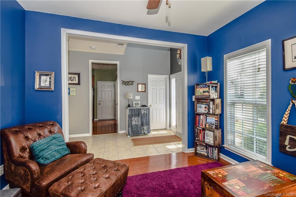 225 Mott Road Mooresville, NC 28115 - Photo 17 of 24 a living room with furniture a bookshelf and a window