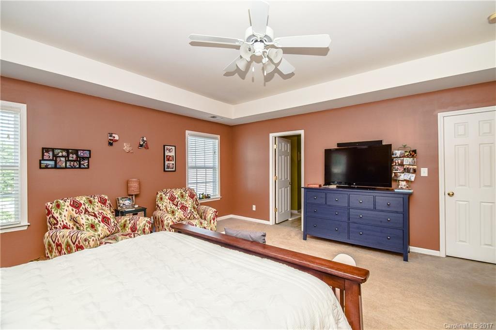 225 Mott Road Mooresville, NC 28115 - Photo 20 of 24 a bedroom with a bed and flat screen tv