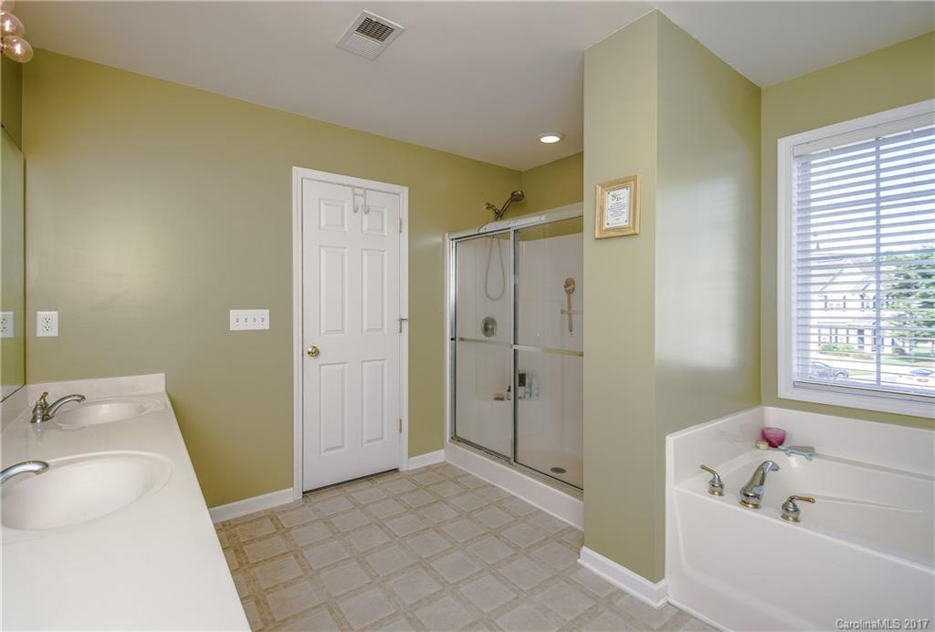 225 Mott Road Mooresville, NC 28115 - Photo 21 of 24 a bathroom with a tub sink and mirror