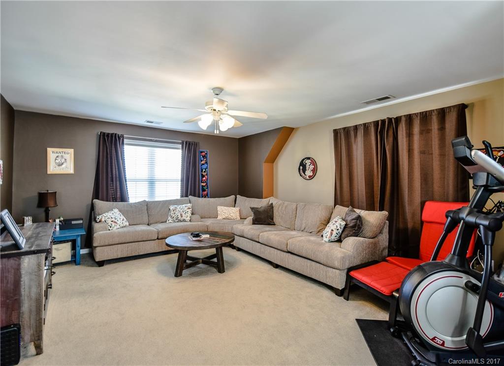 225 Mott Road Mooresville, NC 28115 - Photo 22 of 24 a living room with furniture and a mirror