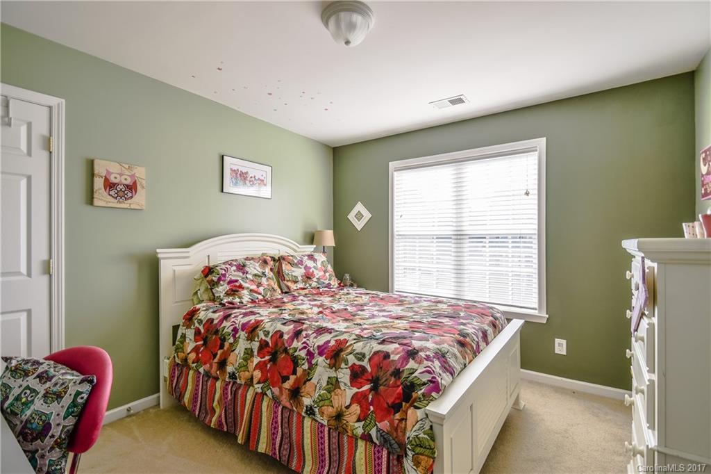 225 Mott Road Mooresville, NC 28115 - Photo 23 of 24 a bedroom with a bed and a window