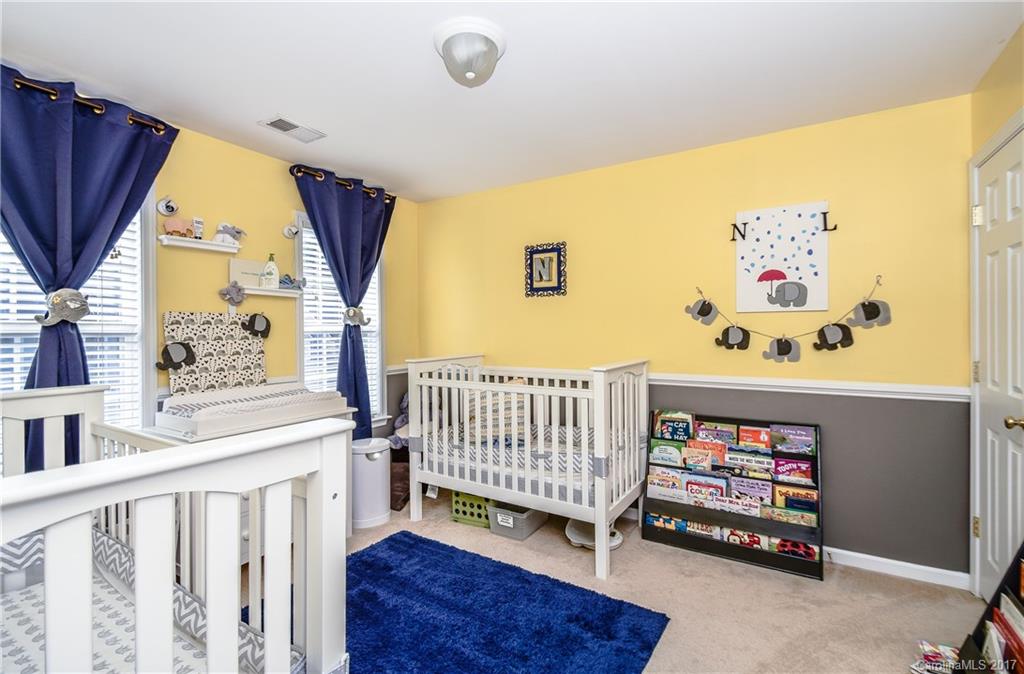 225 Mott Road Mooresville, NC 28115 - Photo 24 of 24 a bedroom with a baby bed a couch and dresser next to a window