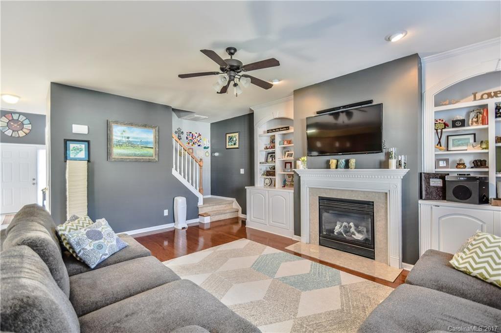 225 Mott Road Mooresville, NC 28115 - Photo 7 of 24 a living room with furniture a fireplace and a flat screen tv