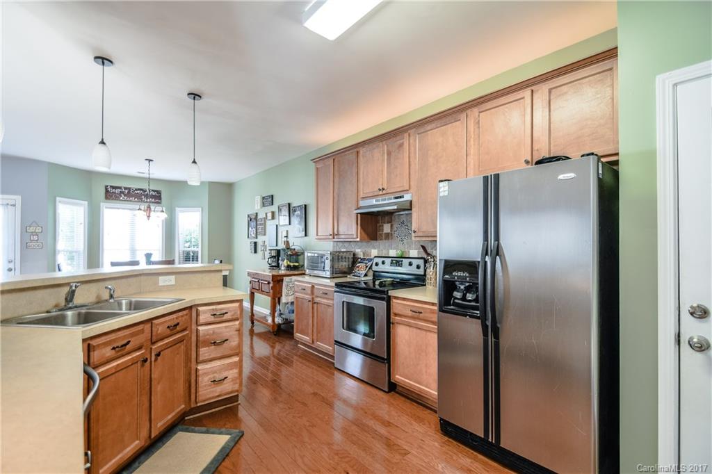 225 Mott Road Mooresville, NC 28115 - Photo 10 of 24 a large kitchen with cabinets stainless steel appliances and a window