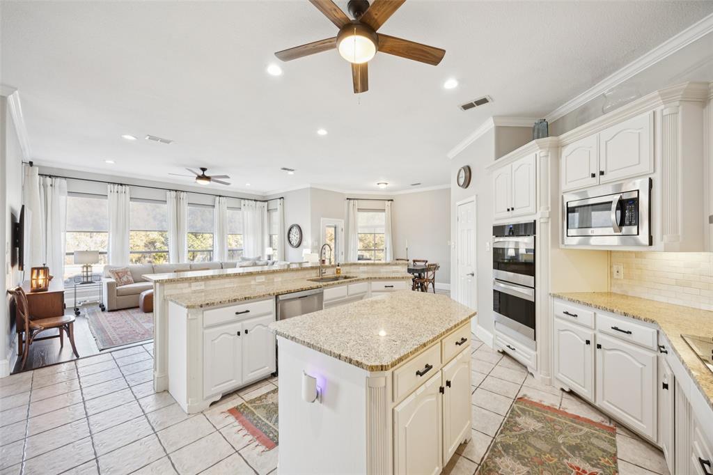 3611 Skinner Road Midlothian, TX 76065 - Photo 11 of 40 a kitchen with granite countertop appliances cabinets and furniture