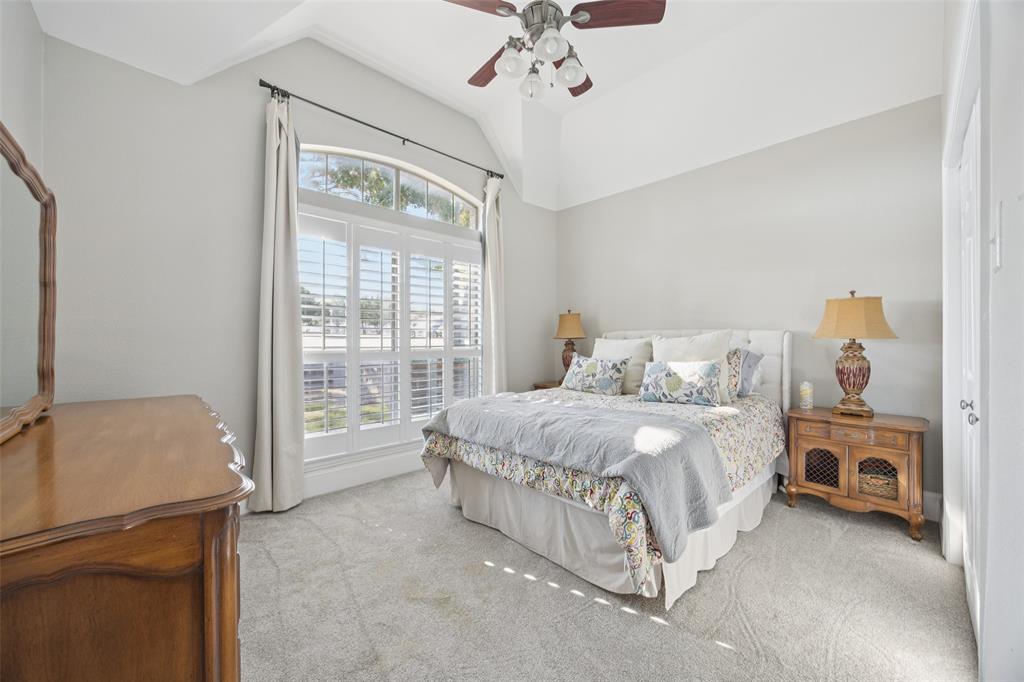 3611 Skinner Road Midlothian, TX 76065 - Photo 14 of 40 a spacious bedroom with a bed and a chandelier