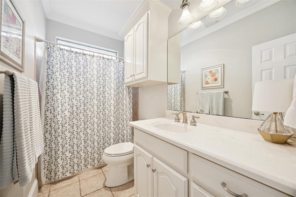 3611 Skinner Road Midlothian, TX 76065 - Photo 15 of 40 a bathroom with a sink a toilet and shower curtain