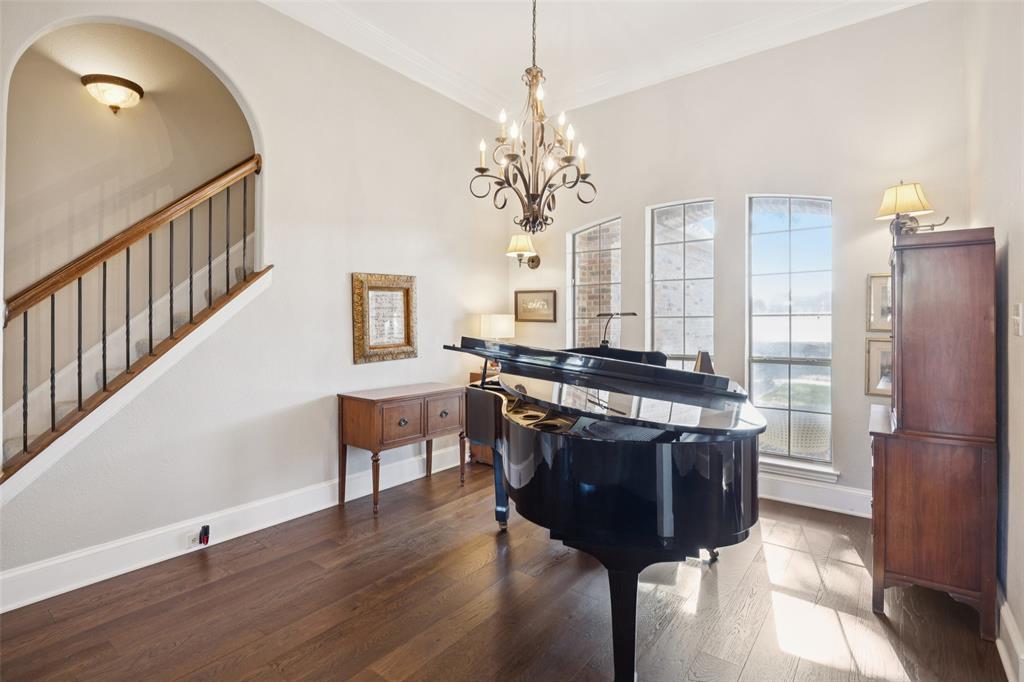 3611 Skinner Road Midlothian, TX 76065 - Photo 4 of 40 a living room with a dining table wooden floor and a chandelier