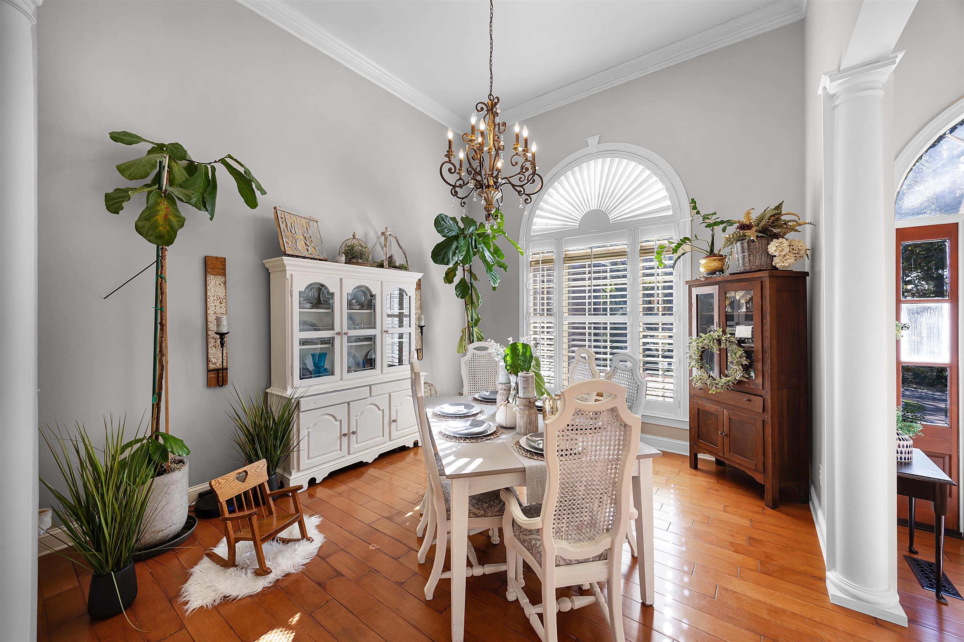 140 Legends Drive Counce, TN 38326 - Photo 14 of 30 Dining room with ornate columns, light wood-style flooring, crown molding, and a chandelier