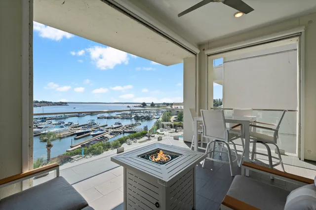 a view of a city from a balcony with furniture