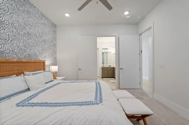 a spacious bedroom with a bed and a couch