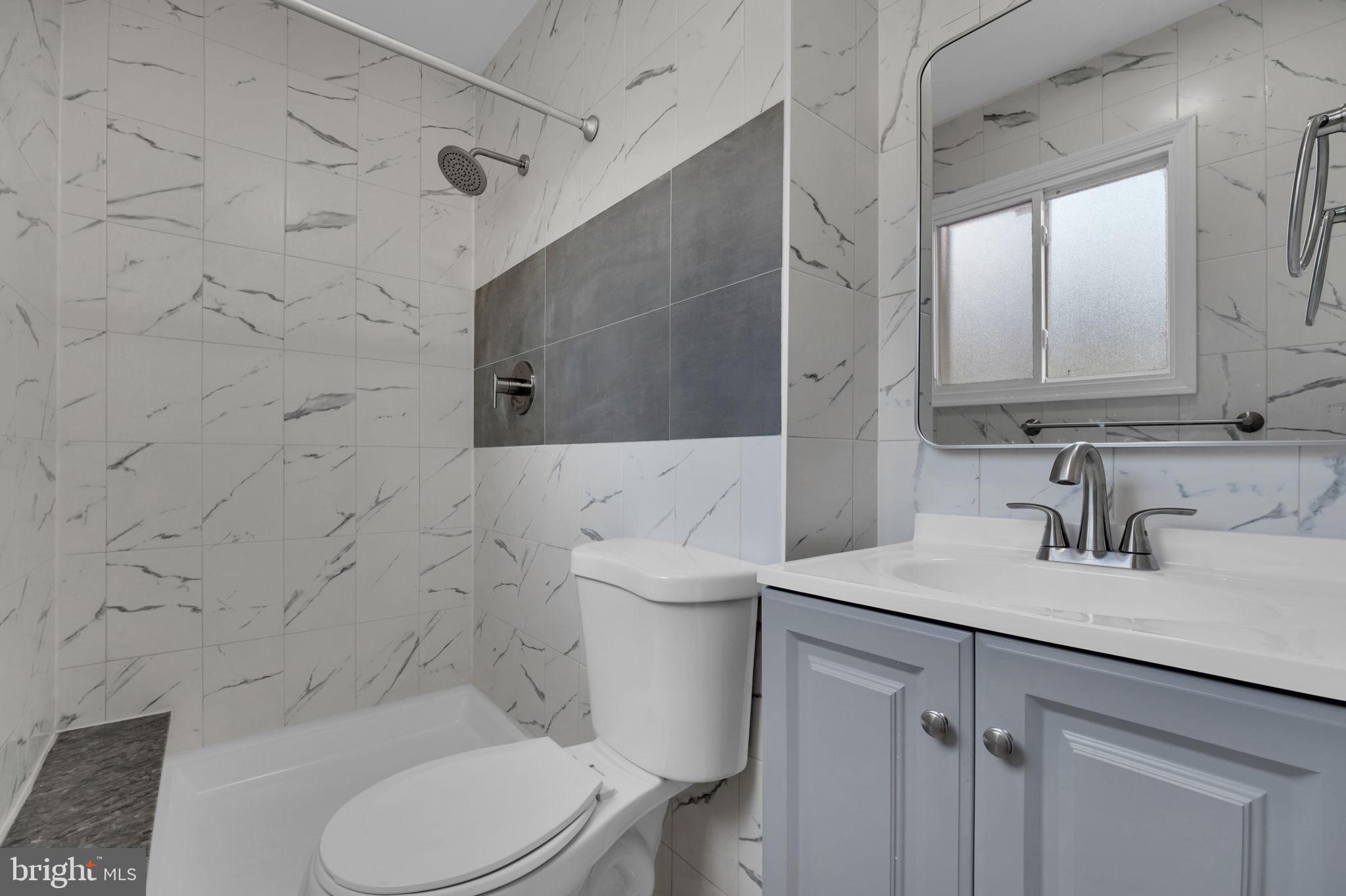 8613 Weems Road Manassas, VA 20110 - Photo 16 of 50 a bathroom with a sink toilet vanity and shower