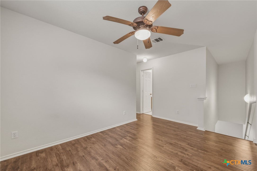 109 Comal Cove Elgin, TX 78621 - Photo 15 of 34 a view of an empty room with wooden floor