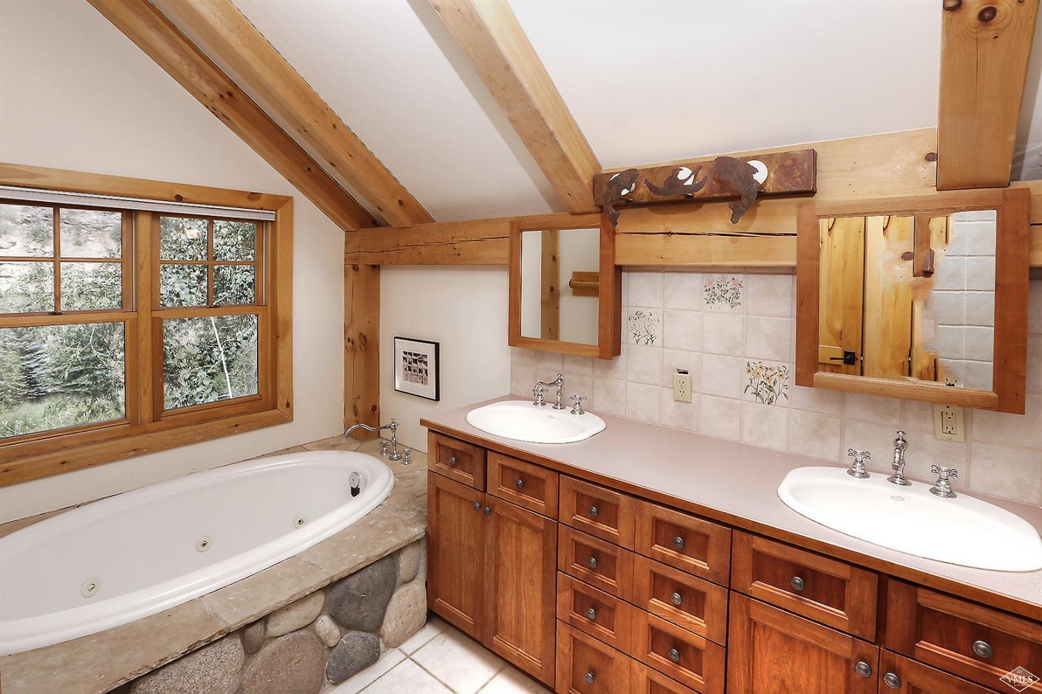440 Eagle River Street Minturn, CO 81645 - Photo 11 of 24 a bathroom with a granite countertop tub sink and mirror