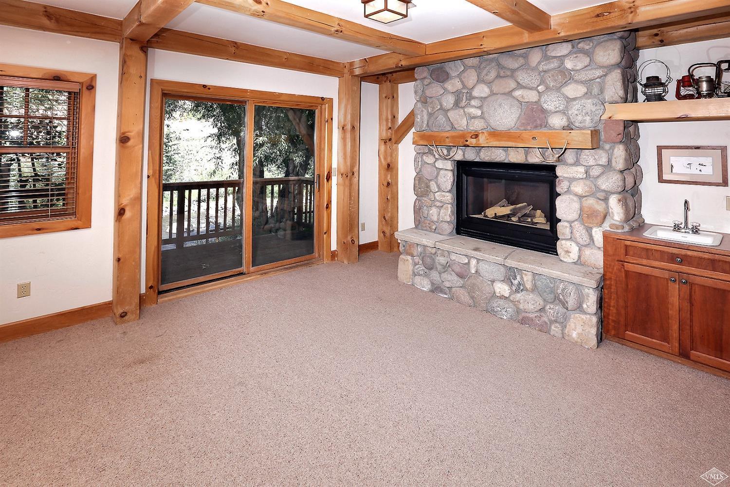 440 Eagle River Street Minturn, CO 81645 - Photo 14 of 24 a view of an empty room with a fireplace and a window