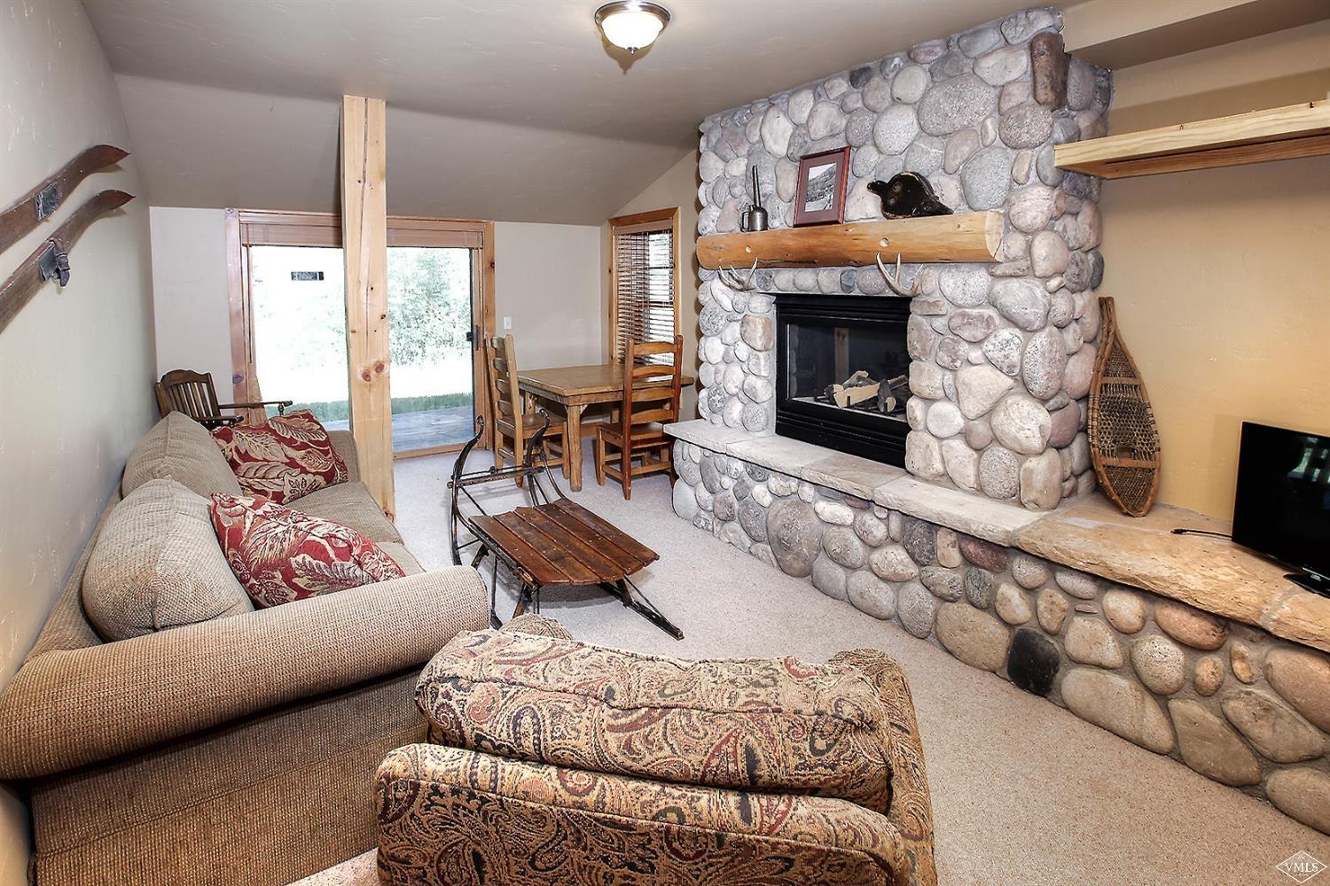 440 Eagle River Street Minturn, CO 81645 - Photo 17 of 24 a living room with furniture fireplace and a fireplace