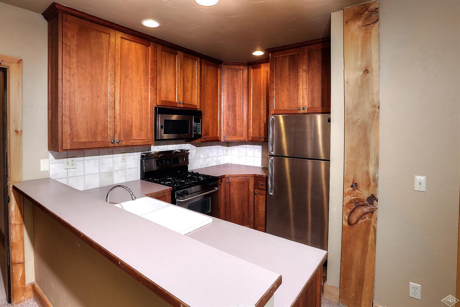 440 Eagle River Street Minturn, CO 81645 - Photo 19 of 24 a kitchen with a refrigerator and a sink