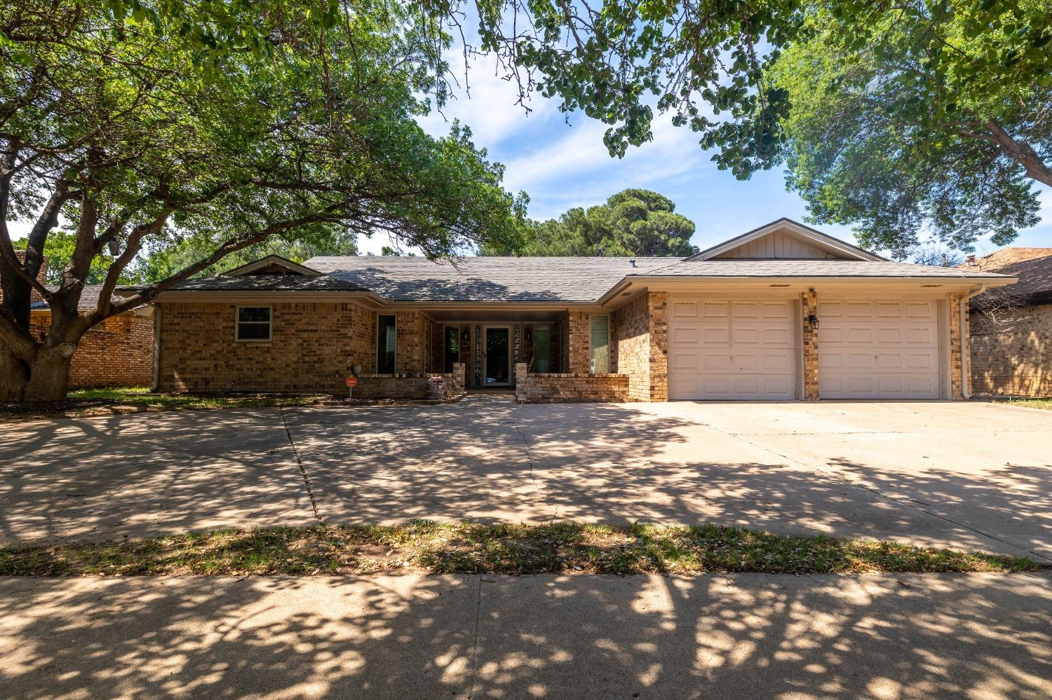 4522 79th Street Lubbock, TX 79424 - Photo 1 of 14 a front view of a house with a garden