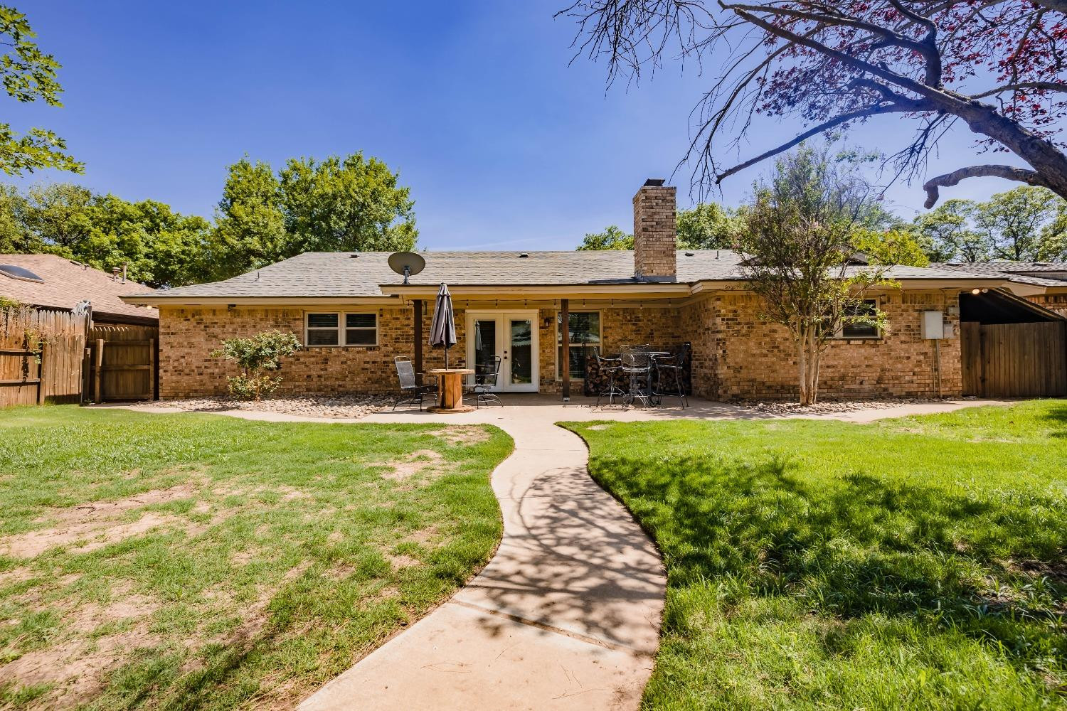 4522 79th Street Lubbock, TX 79424 - Photo 12 of 14 a front view of a house with garden