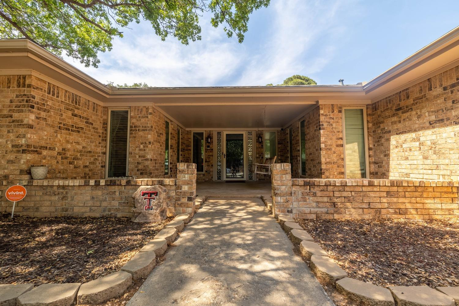 4522 79th Street Lubbock, TX 79424 - Photo 2 of 14 a view of a brick house with large windows