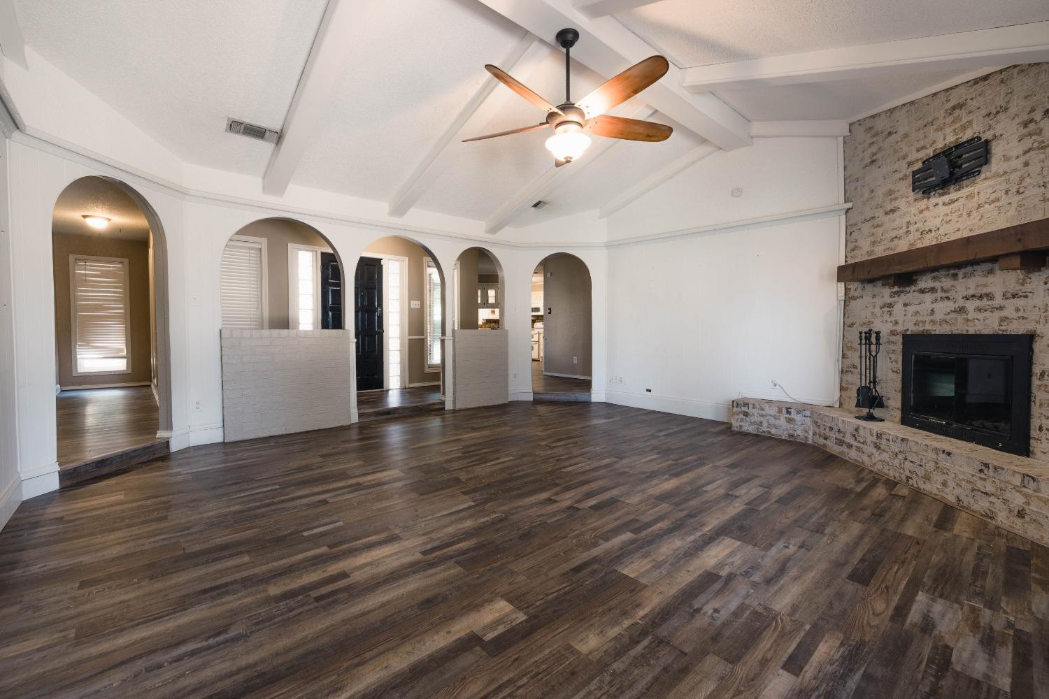 4522 79th Street Lubbock, TX 79424 - Photo 3 of 14 a view of an empty room with wooden floor and a fireplace