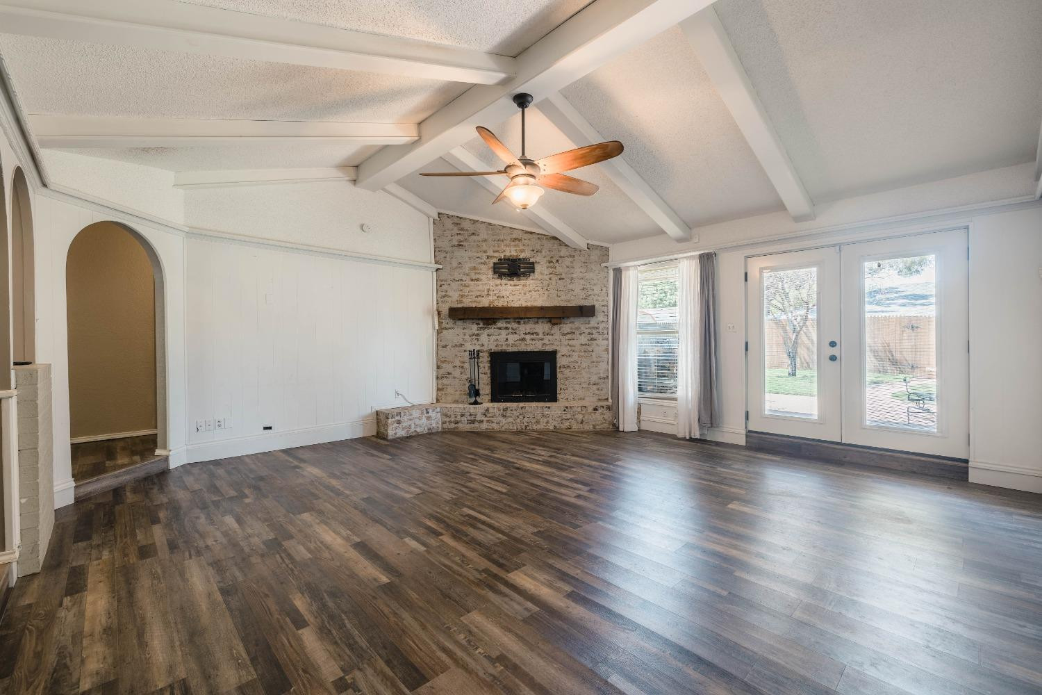 4522 79th Street Lubbock, TX 79424 - Photo 4 of 14 a view of an empty room with window and wooden floor