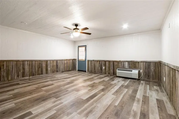 a view of a bedroom with wooden floor