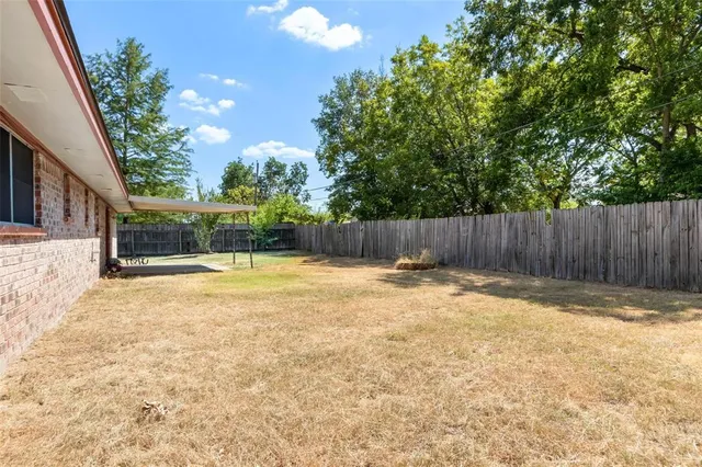 a view of swimming pool with wooden fence