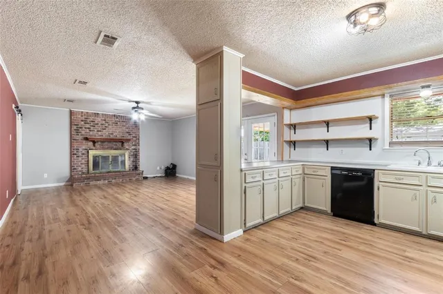 a kitchen with a refrigerator and a stove top oven