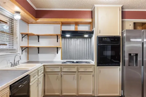 a kitchen with cabinets and stainless steel appliances