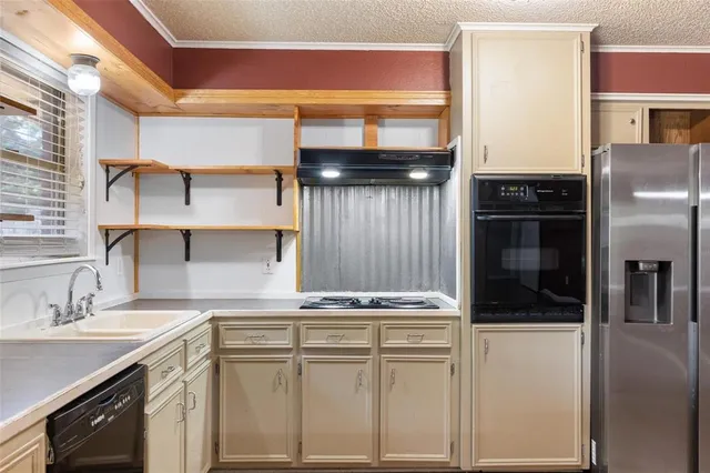 a kitchen with cabinets and stainless steel appliances