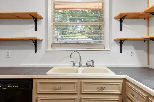 a bathroom with a sink and a window