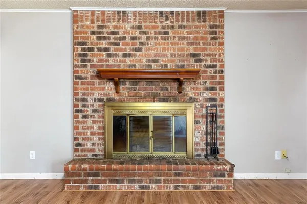 a view of a fireplace with wooden floor