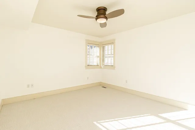 a bathroom with a granite countertop toilet a sink a mirror and shower