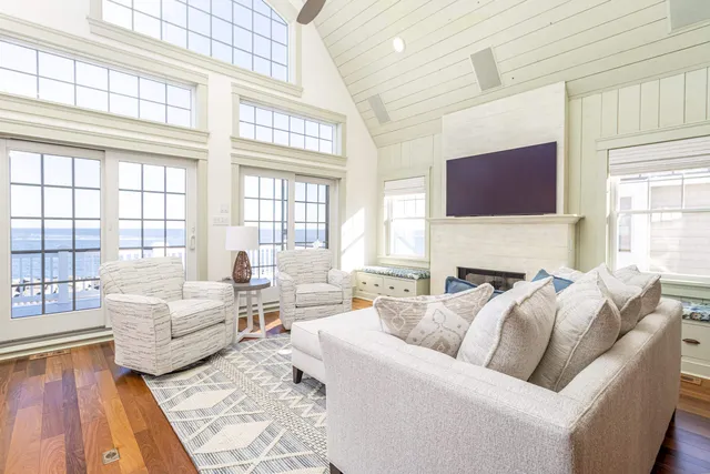 a dining room with furniture a chandelier and wooden floor