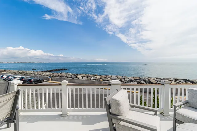 a living room with fireplace furniture and a chandelier