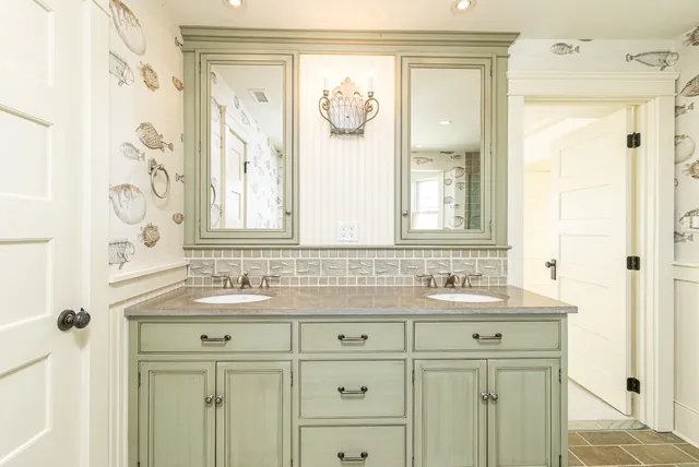 a white bath tub sitting next to a bathroom sink