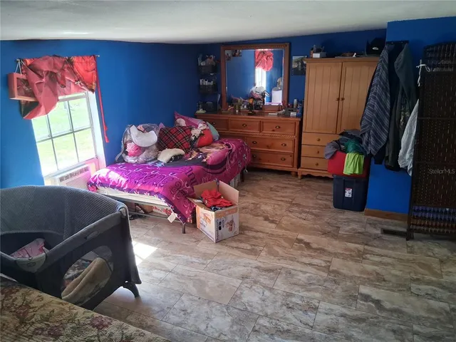 a bedroom with furniture and a flat screen tv