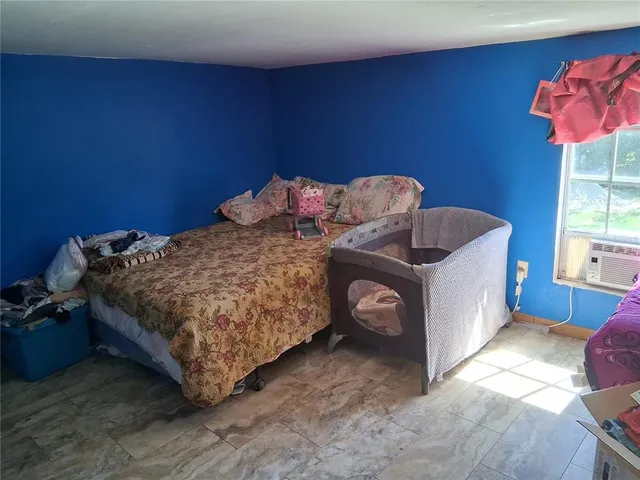 a bedroom with a bed and a dresser